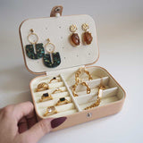 A stunning apricot jewellery box which is perfectly sized for travel display several pieces of jewellery including the best selling Alethea earrings which are gold and brown