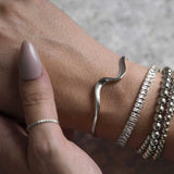 Woman Wearing Sterling Silver Resilience Classic Minimal Ring & Silver Bracelets Bangle